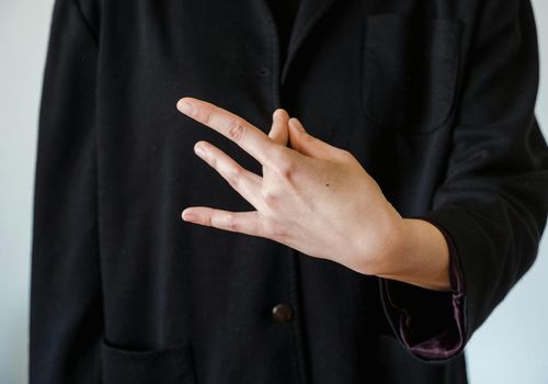 Close-up of hands in a mindful gesture during practice.